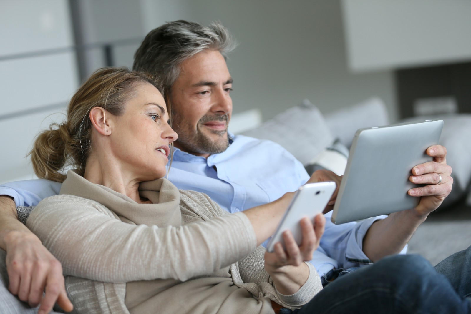 couple talking and looking at the tablet device